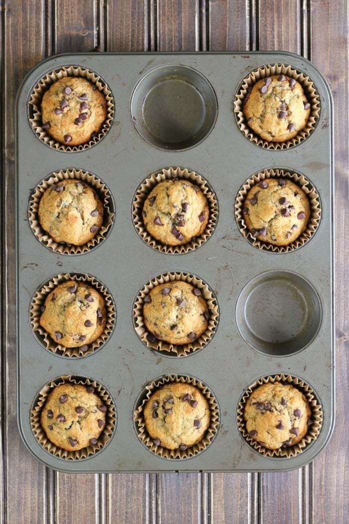 Whole wheat banana muffins with chocolate chips make a healthy choice for snack time or breakfast! Make a bunch and pop them in the freezer.