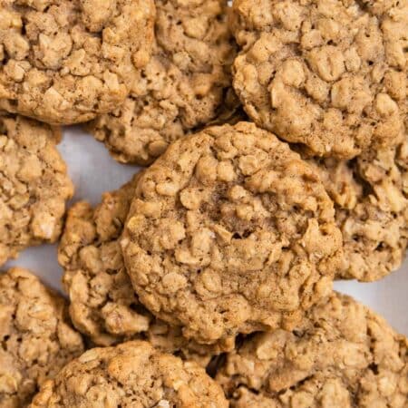 Old-fashioned oatmeal walnut cookies sitting on a baking sheet.