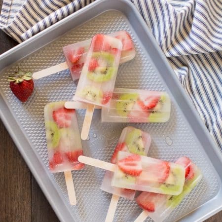 Easy homemade strawberry kiwi popsicles made without sugar! Just a few fresh ingredients and some coconut water is all you need!