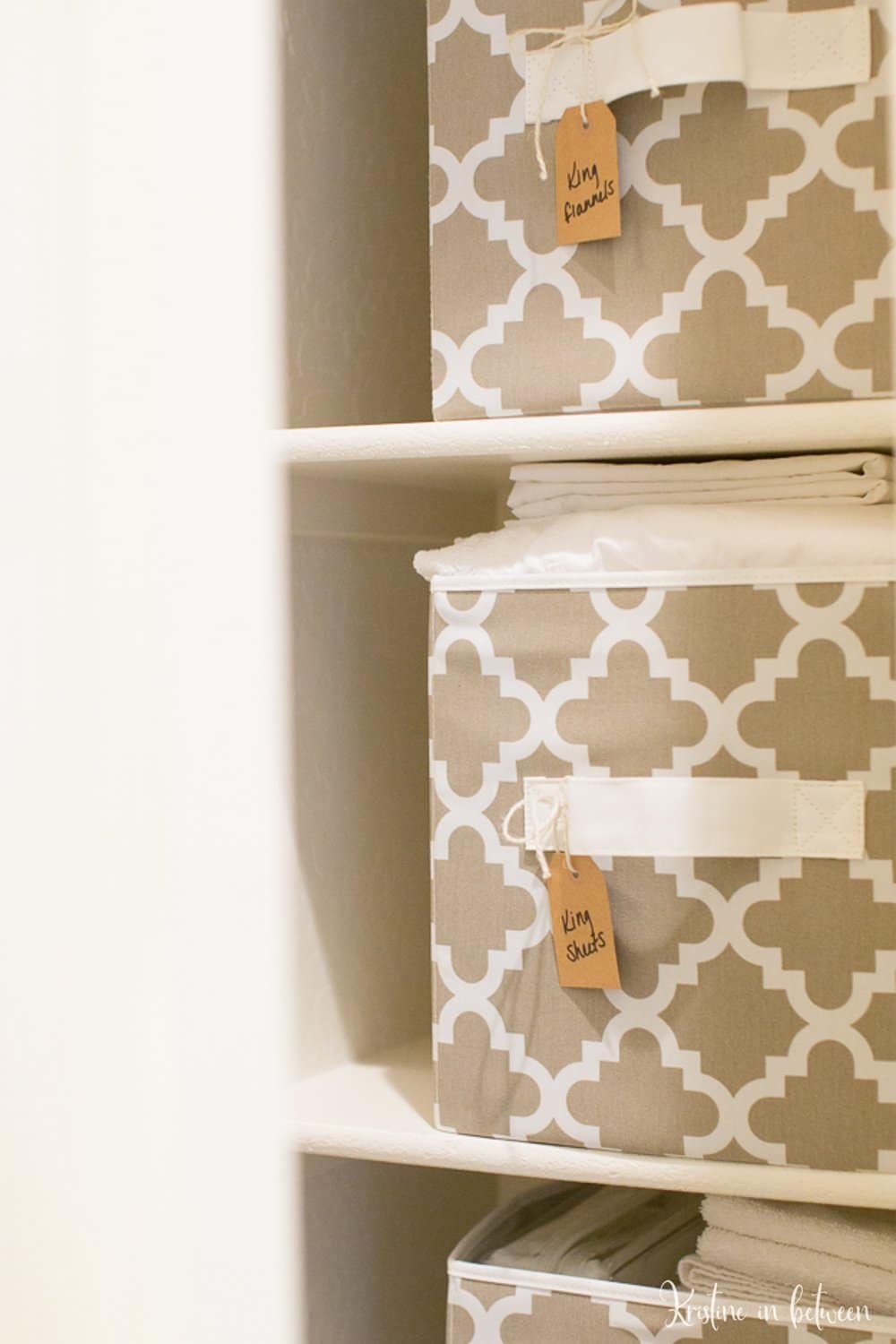 Sheets folded in bins in a linen closet.