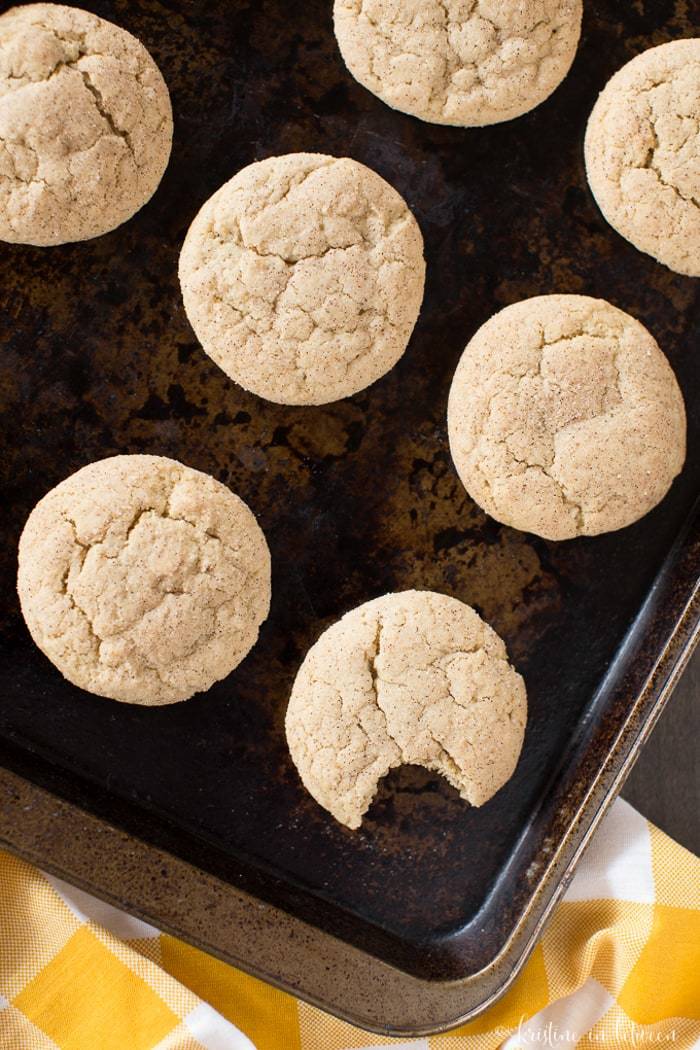 Cookies laying on a baking sheet, showing the cracked tops.