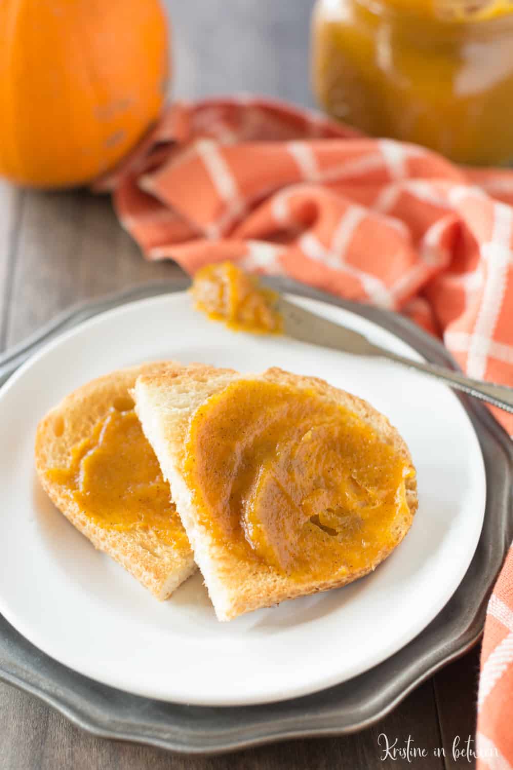 A piece of toast cut in half with pumpkin butter on it.