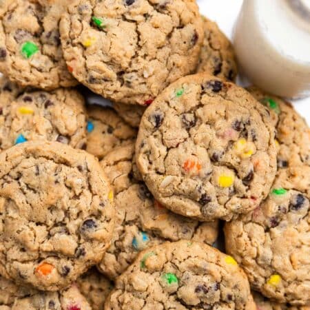 A whole tray of monster cookies sitting with an orange napkin.
