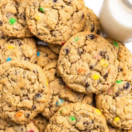 A whole tray of monster cookies sitting with an orange napkin.