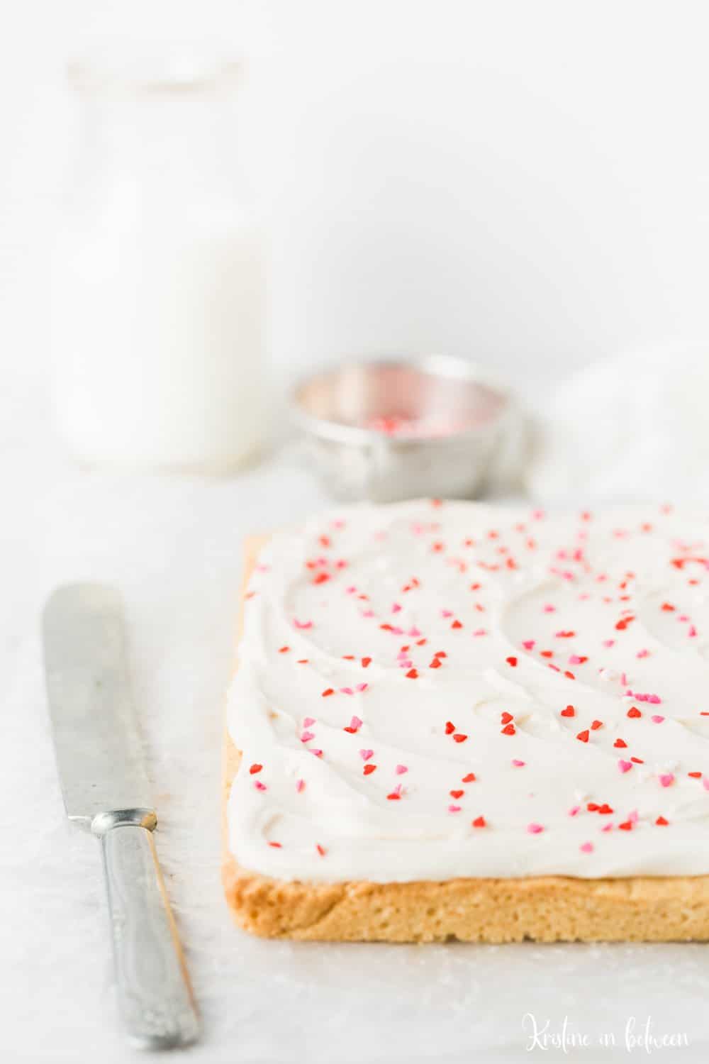Super easy small batch sugar cookie bars with cream cheese frosting!
