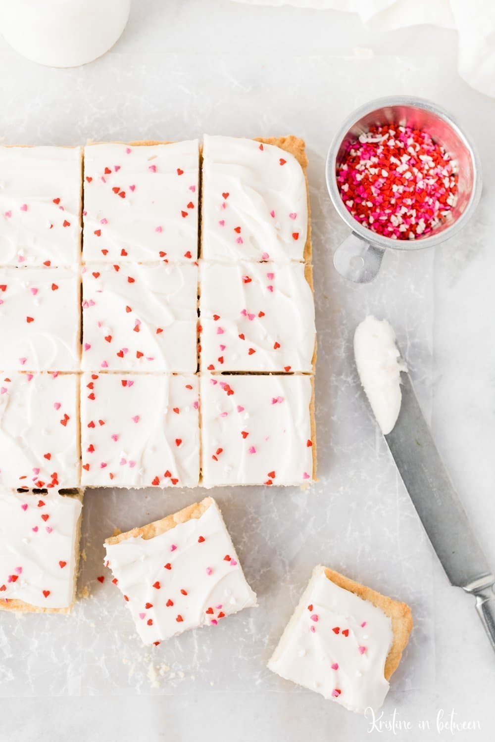Super easy small batch sugar cookie bars with cream cheese frosting!