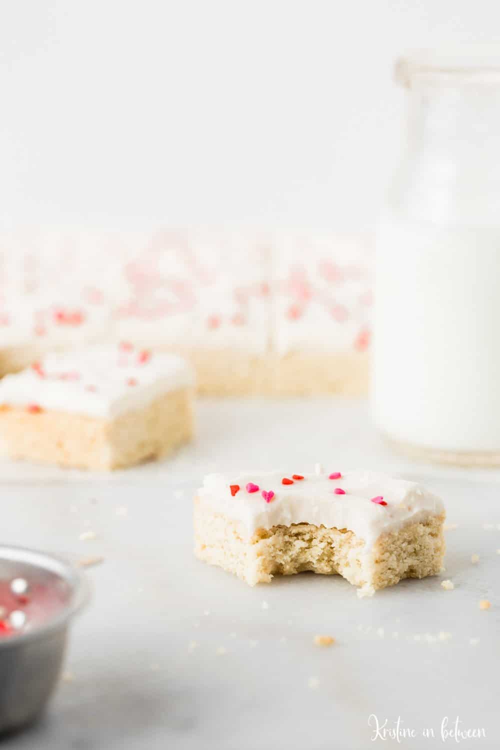 Super easy small batch sugar cookie bars with cream cheese frosting!