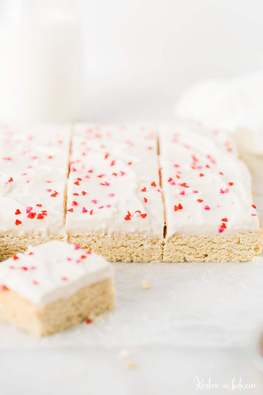 Super easy small batch sugar cookie bars with cream cheese frosting!