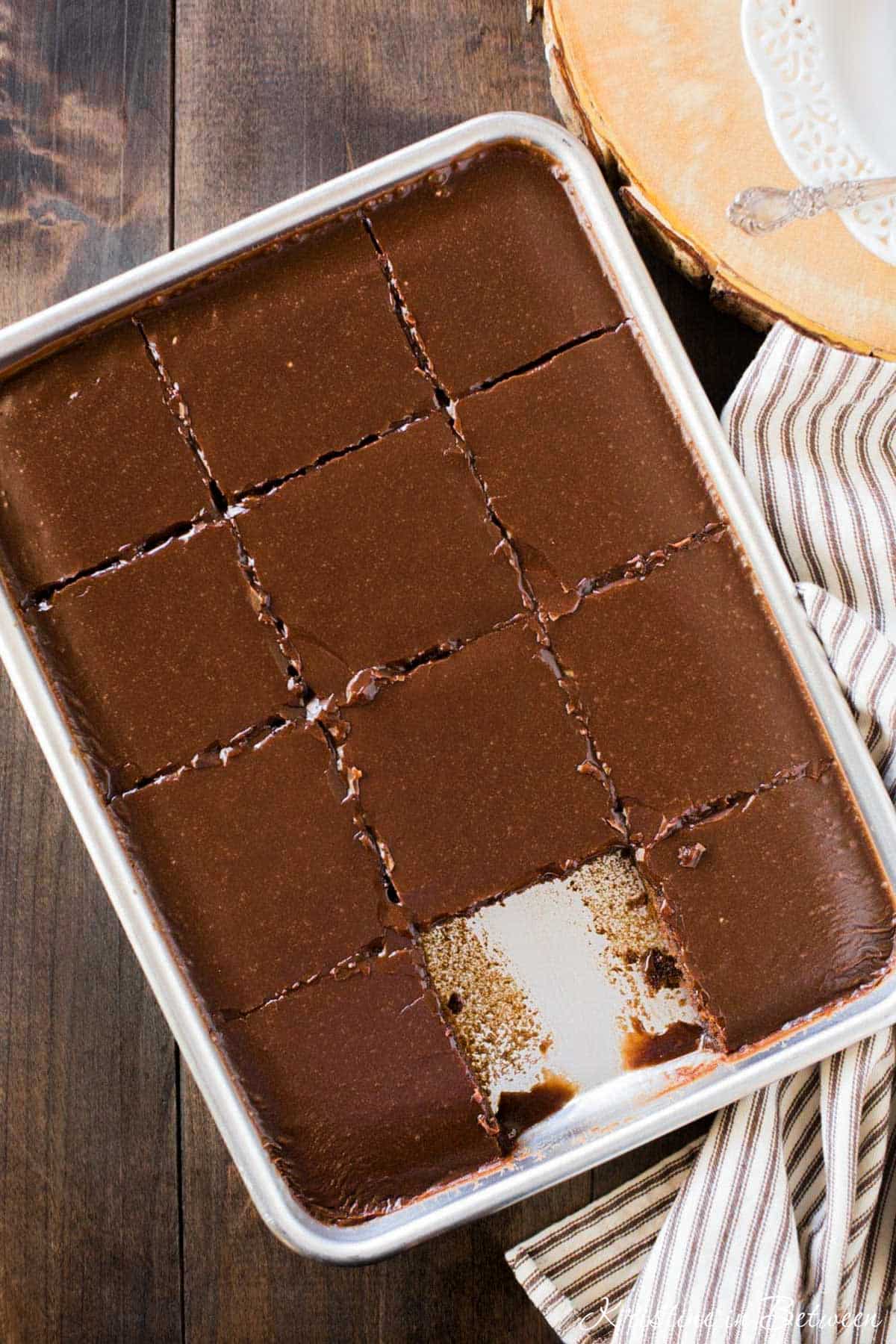 A small-batch Texas sheet cake in a quarter sheet pan, sliced and ready to serve.