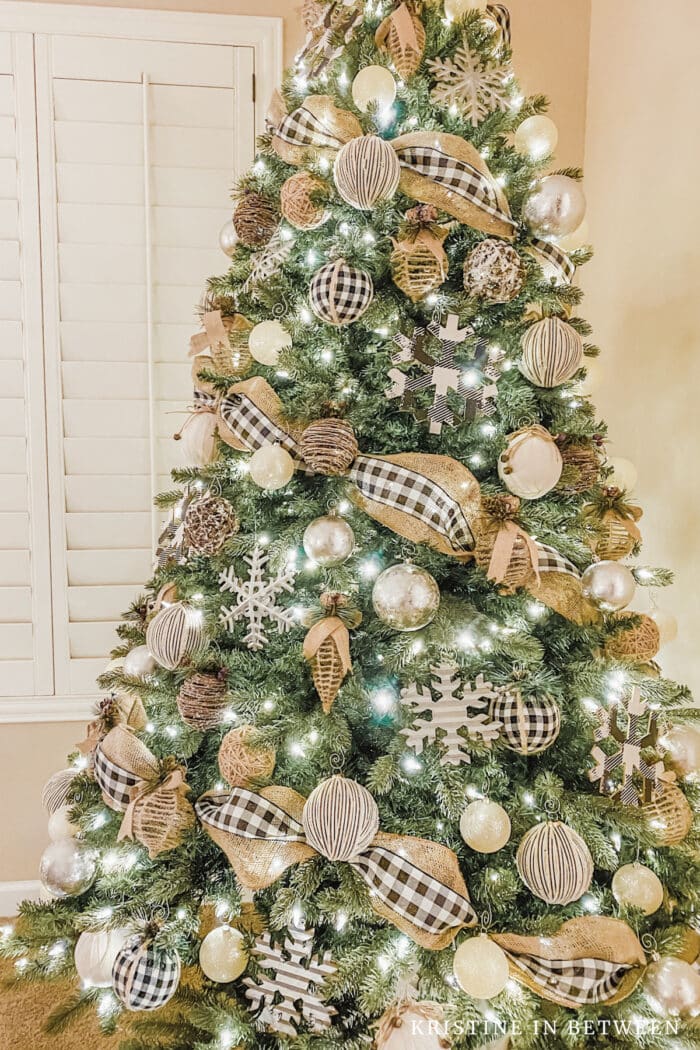 A Christmas tree decorated in burlap, black and white.