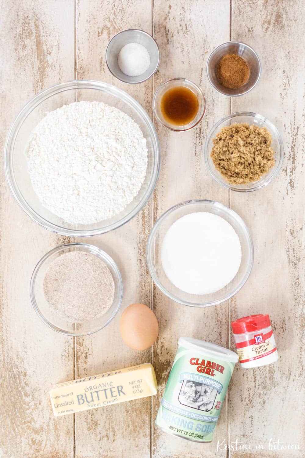 Ingredients needed for this soft snickerdoodle recipe laying on an old white tabletop.