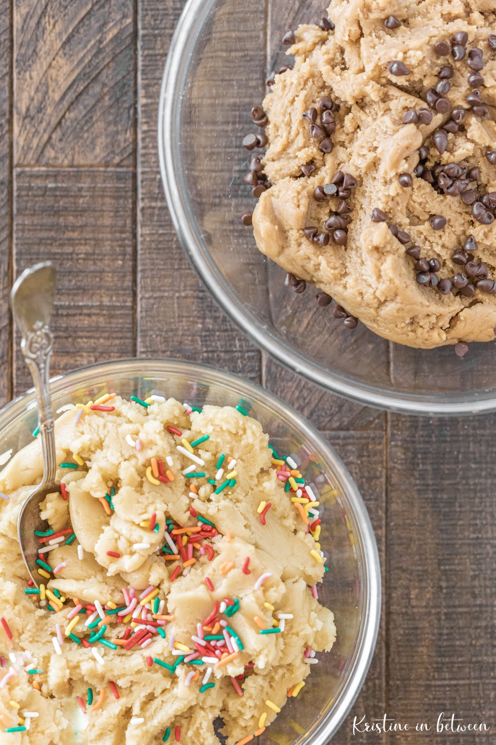 Two bowls of cookie dough sitting on a table.