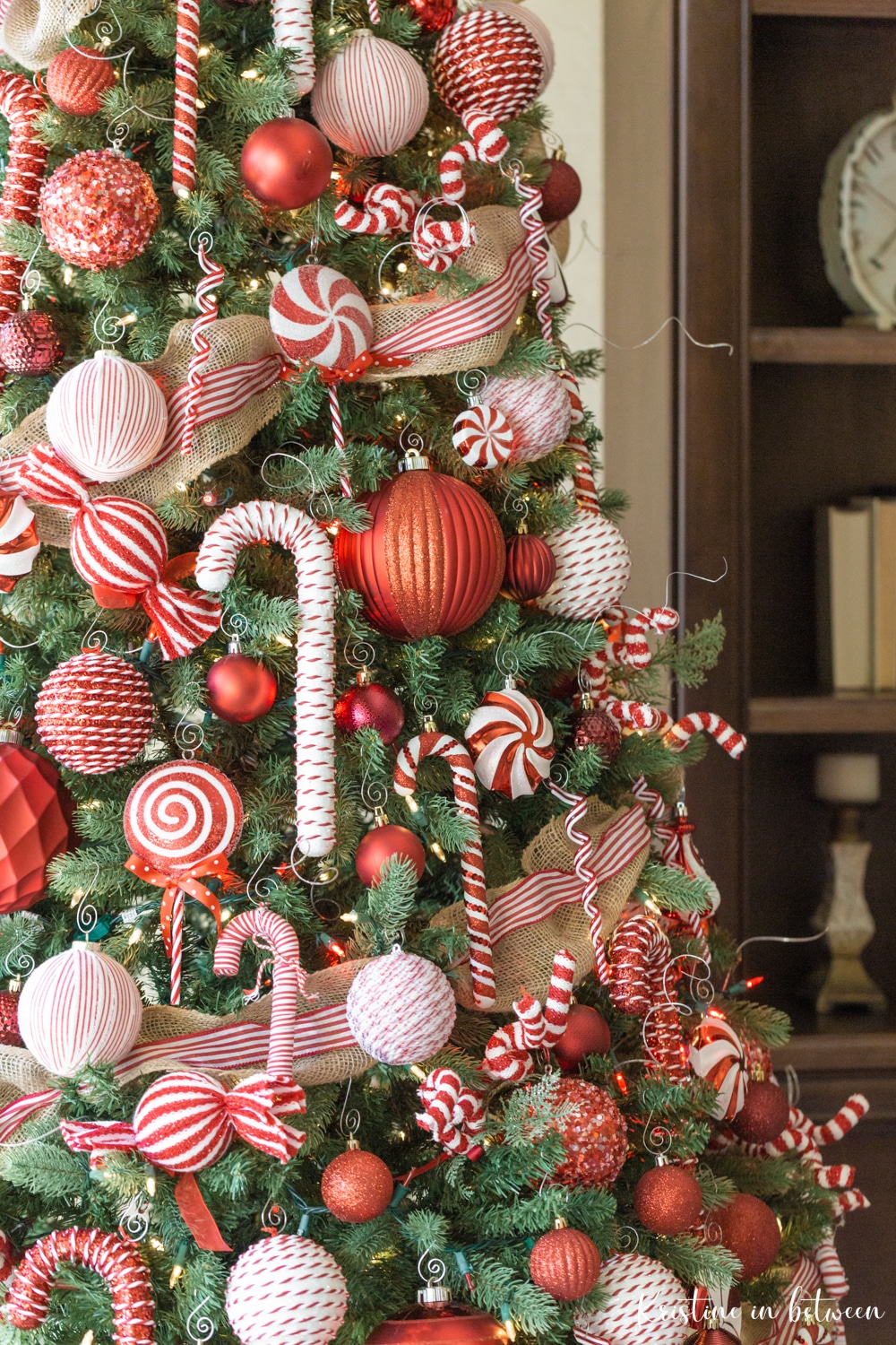 A Christmas tree decorated in red and white candy ornaments.