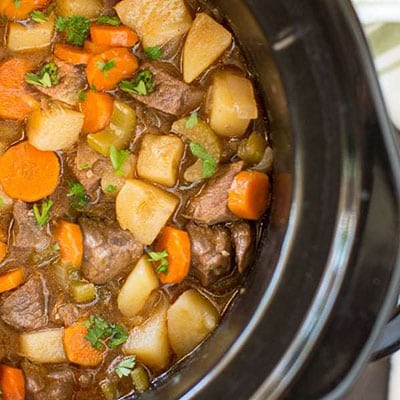 A pot of beef stew with vegetables.