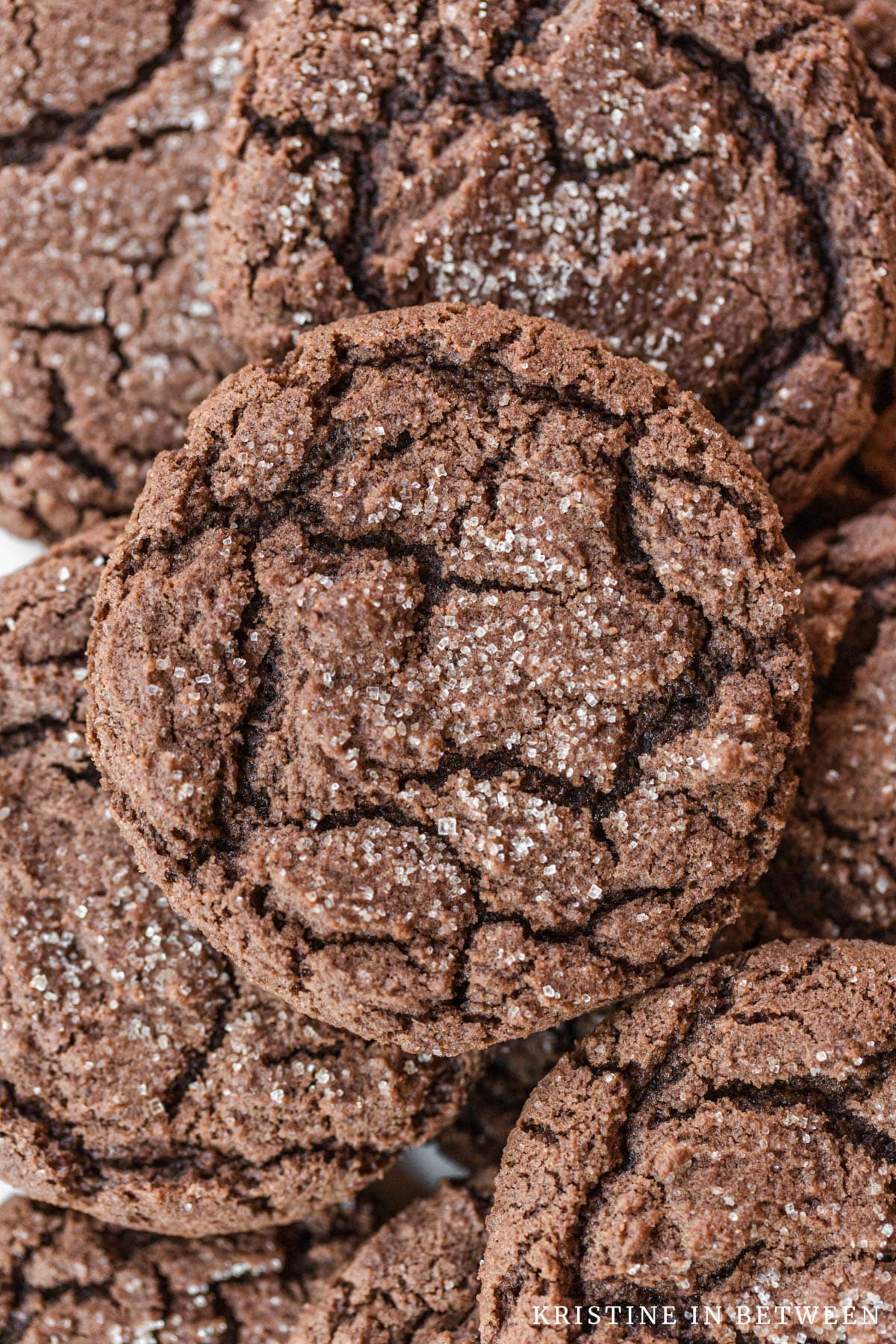 Chocolate cookies stacked up, showing the cracks on the top.