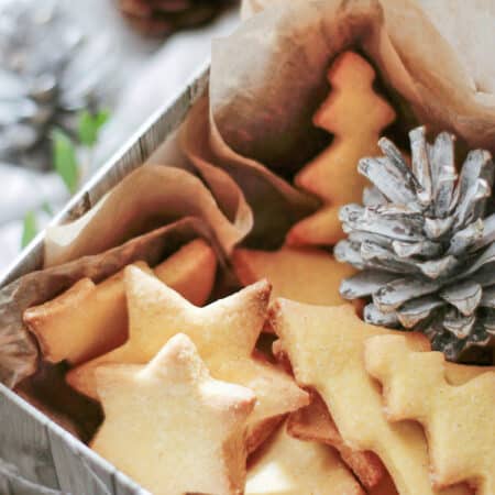 Cut out sugar cookies in a box with tissue paper.