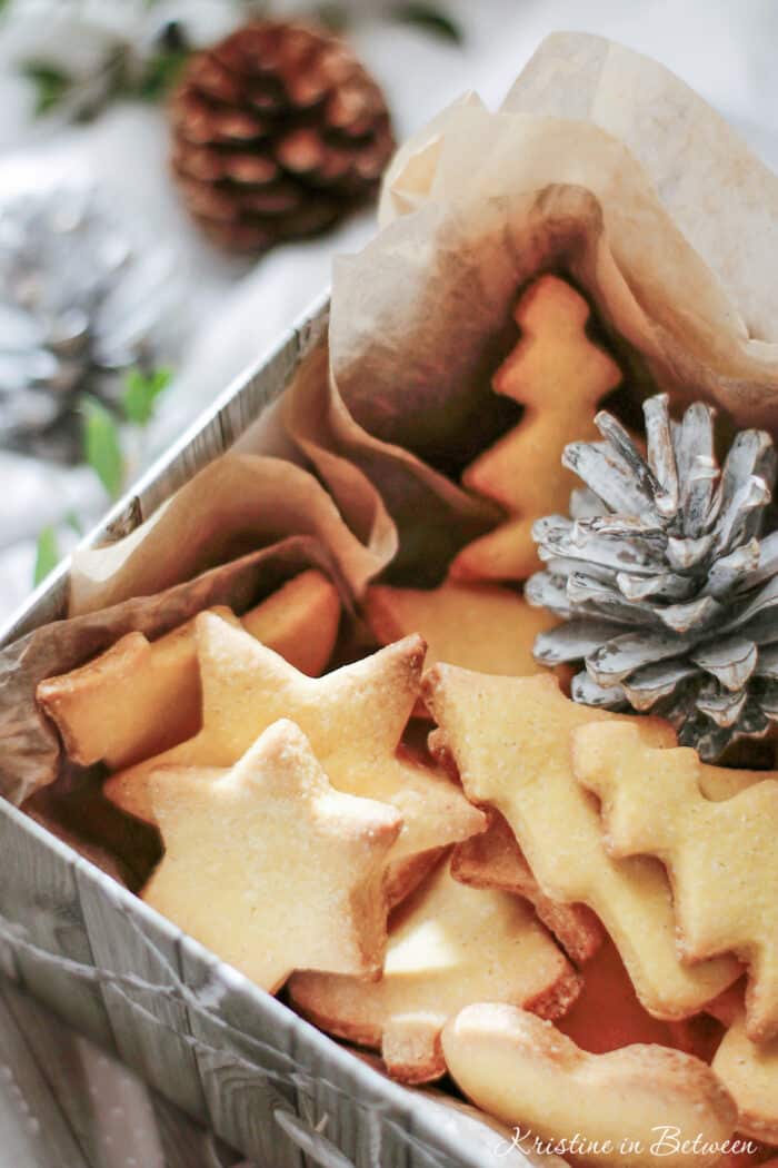 Cut out sugar cookies in a box with tissue paper.