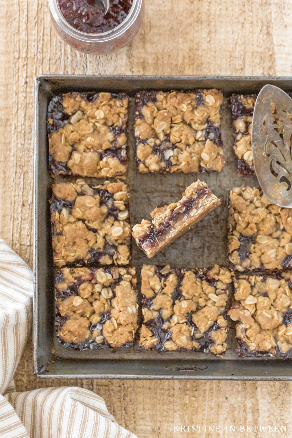 Jam bars in an antique baking pan with one bar on its side to show the inside.