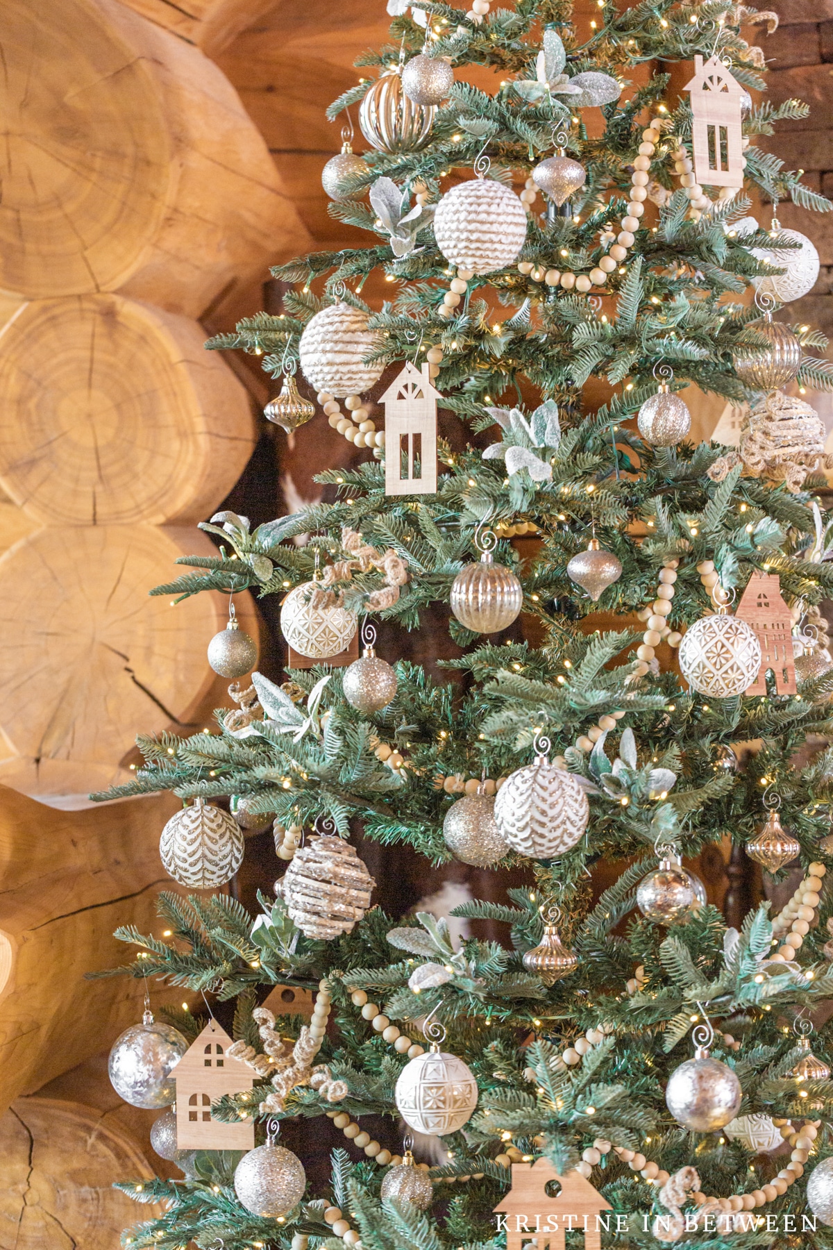 A minimally decorated Christmas tree with neutral colors.