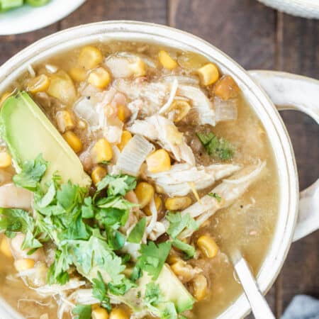 Chicken chili garnished with chopped cilantro and avocado.