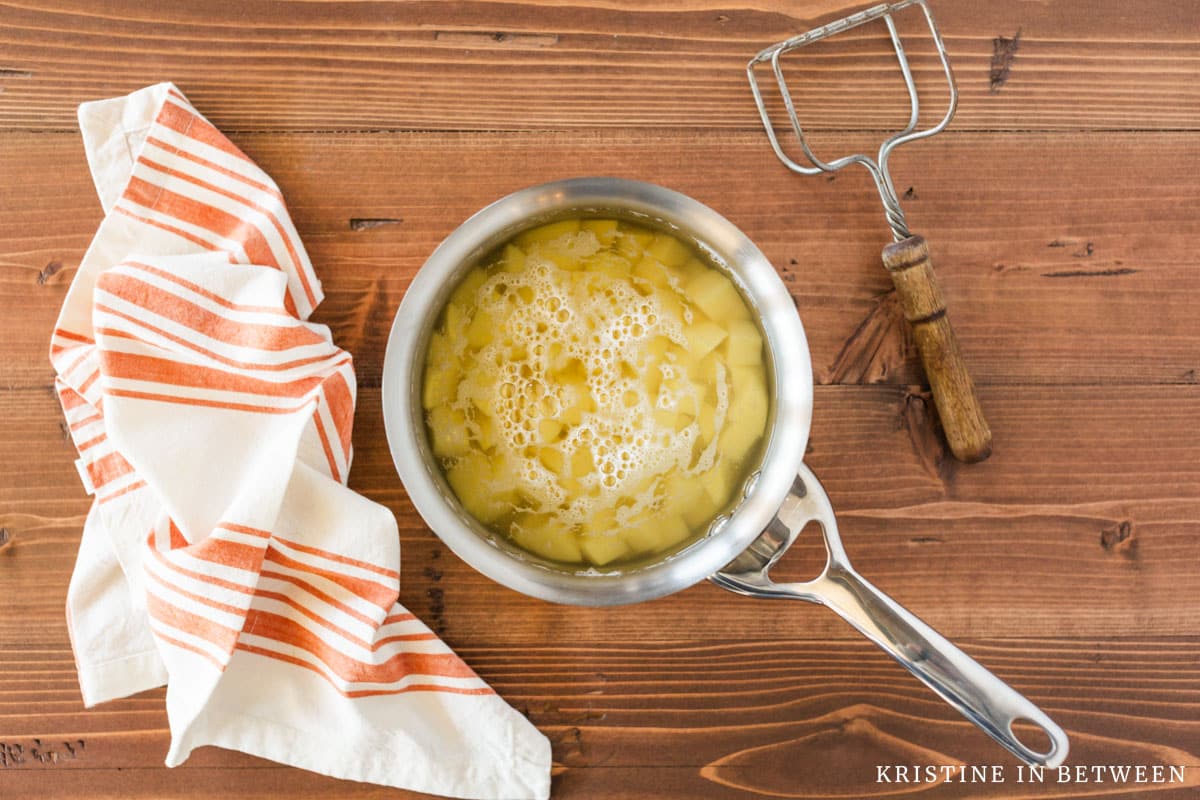 Chopped potatoes in a pan with water.