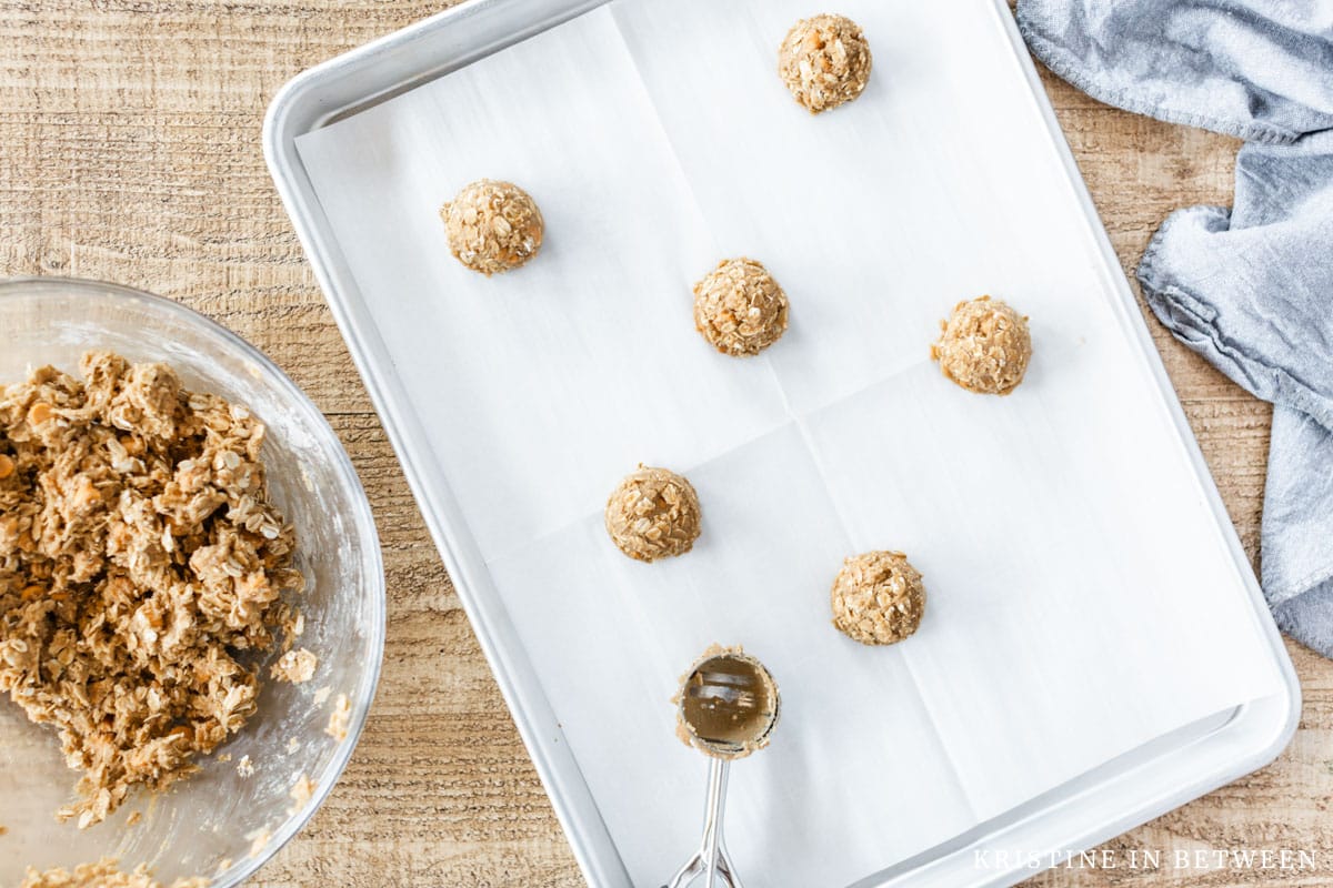Cookies scooped out onto a baking sheet lined with parchment paper. 