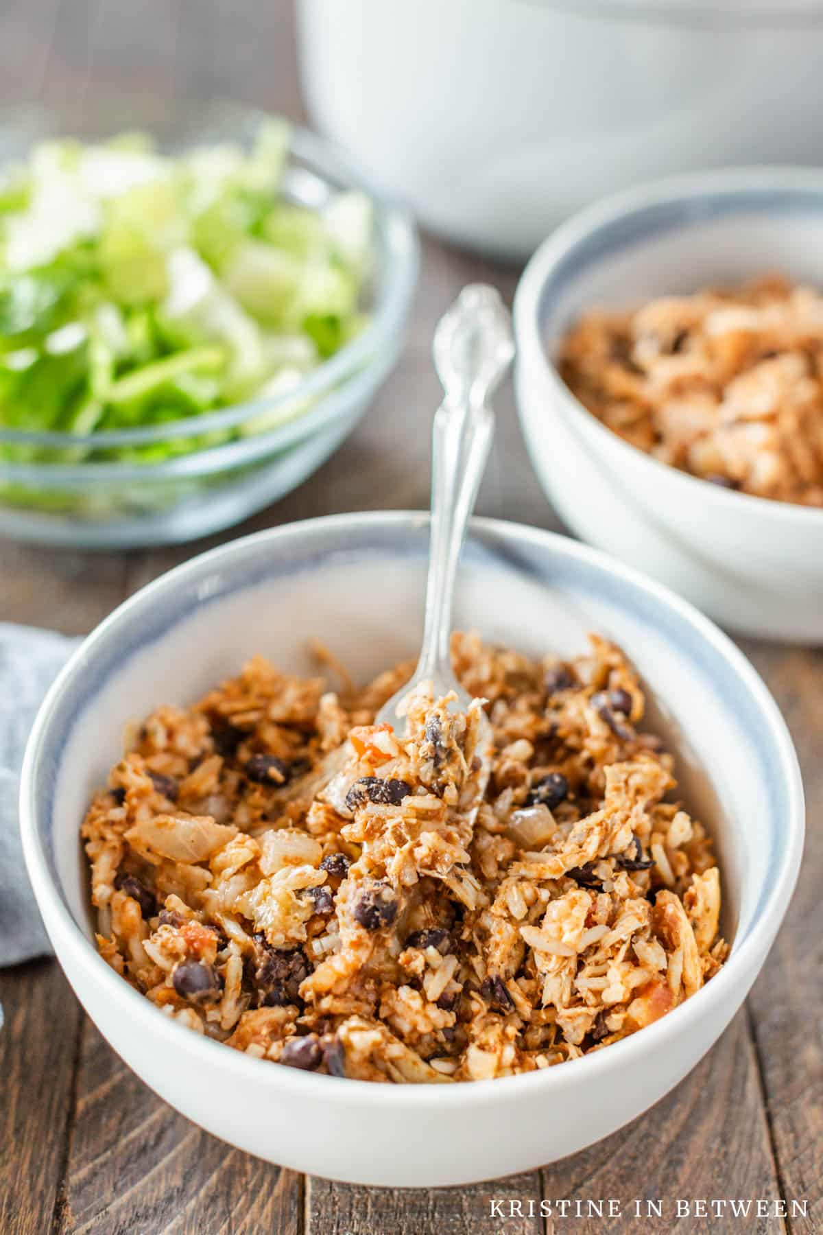 A bowl of chicken taco rice casserole with a fork in it.