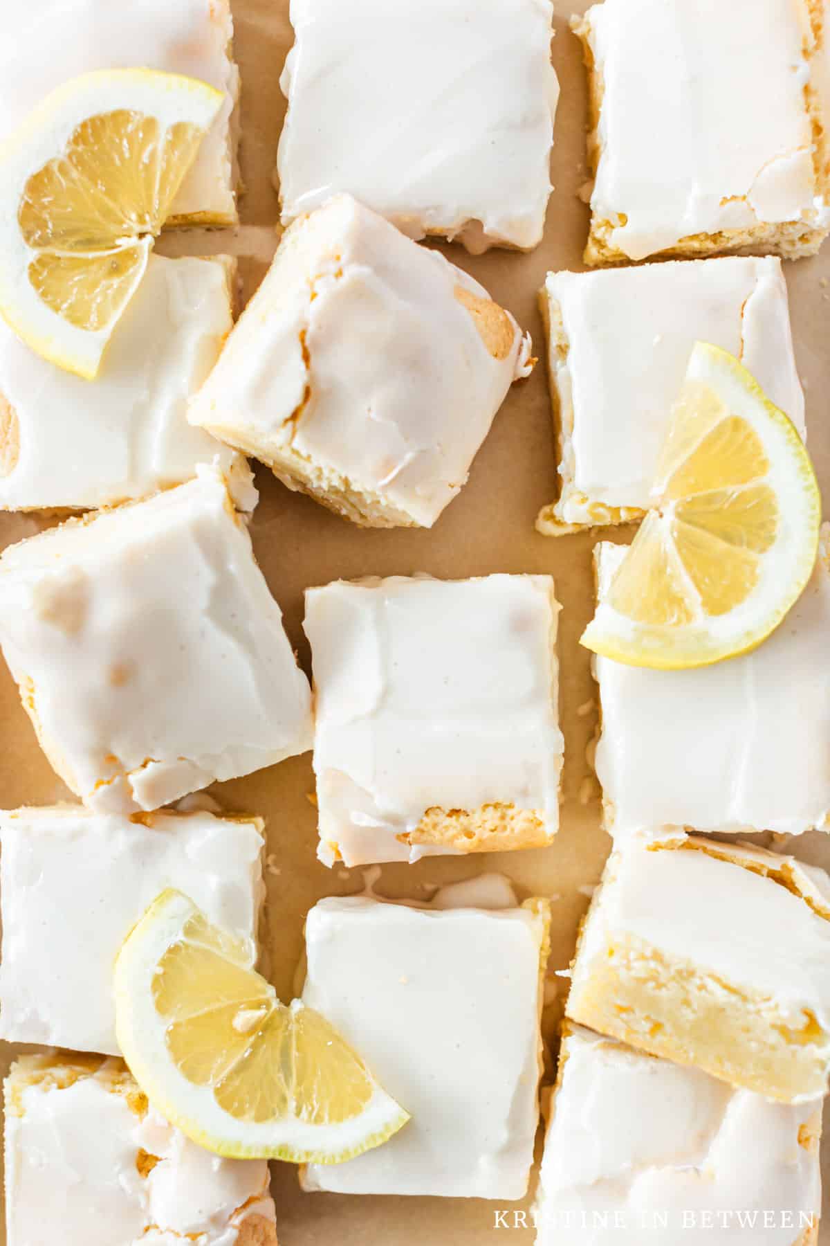 Sliced lemonies laying on parchment paper with sliced lemons on top.