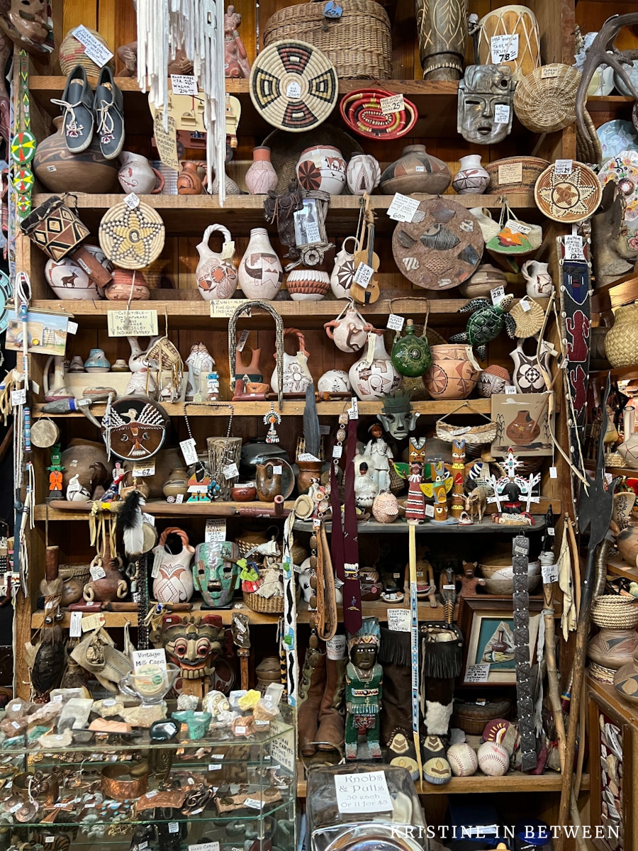 A very cluttered wall full of old antiques.