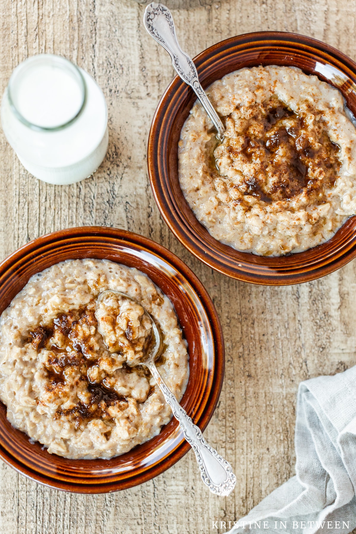 Two bowls of brown sugar cinnamon oatmeal topped with brown sugar and cinnamon.