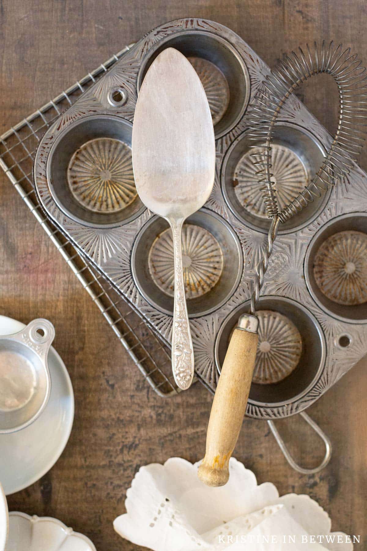 Antique food photography props sprawled out on a wooden board.