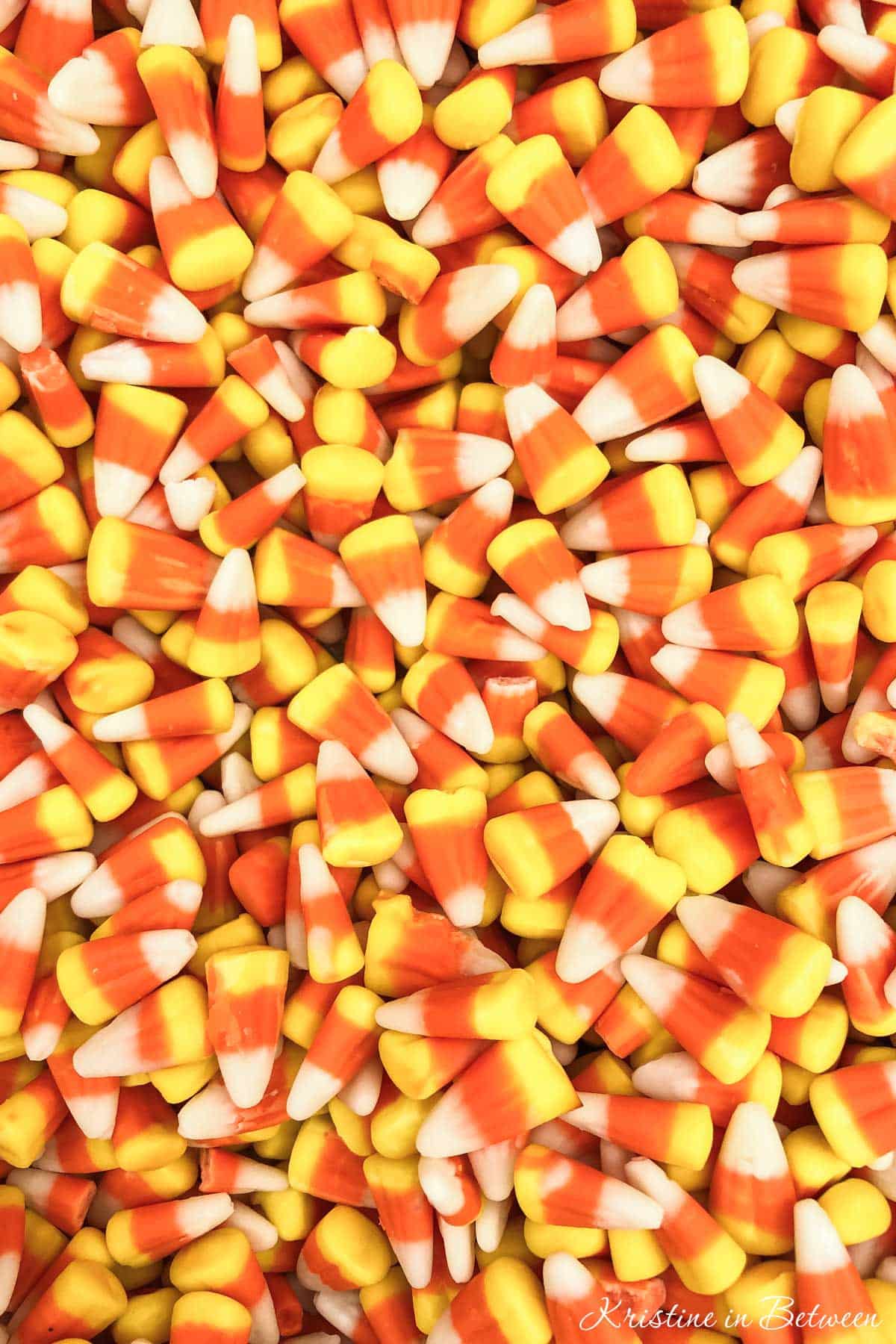 A closeup of candy corn in a bowl, showing the detail of the candy.