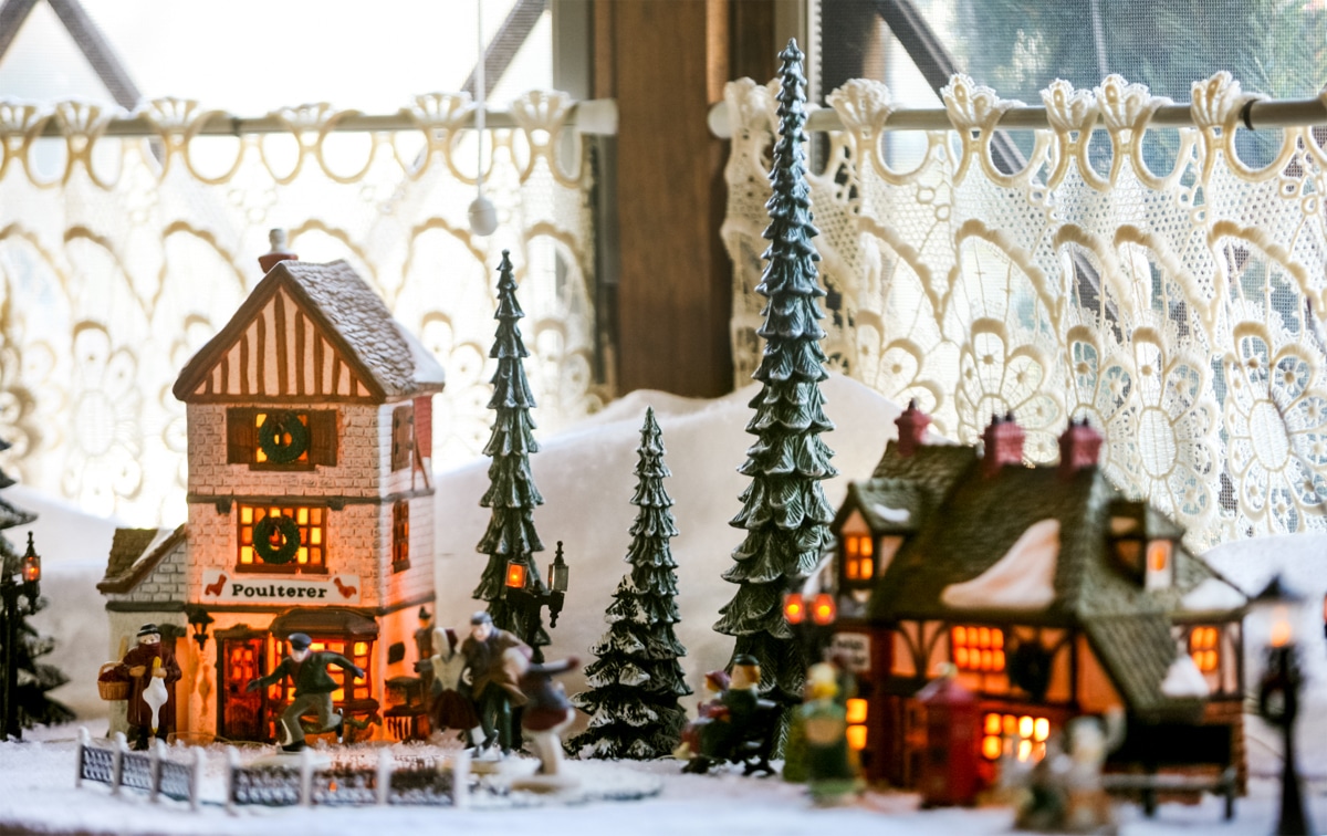 A Christmas village displayed on a kitchen counter.