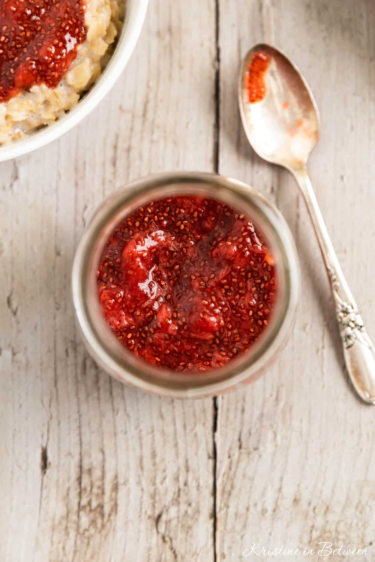 A bowl of oatmeal topped with homemade strawberry chia seed jam.
