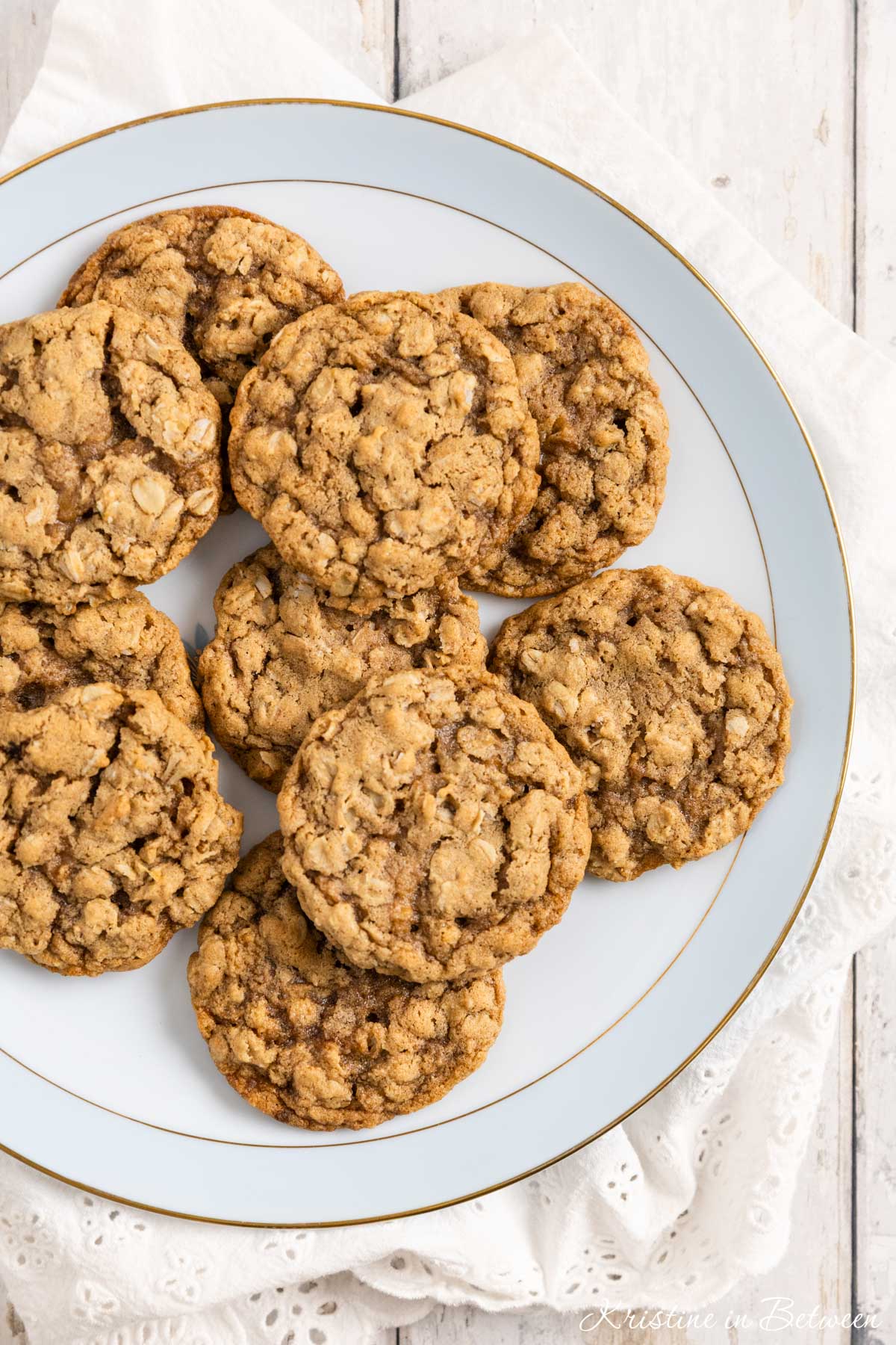 Old-fashioned oatmeal cookies on an antique china plate with an eyelet napkin underneath.