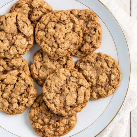 Old-fashioned oatmeal cookies on an antique china plate with an eyelet napkin underneath.