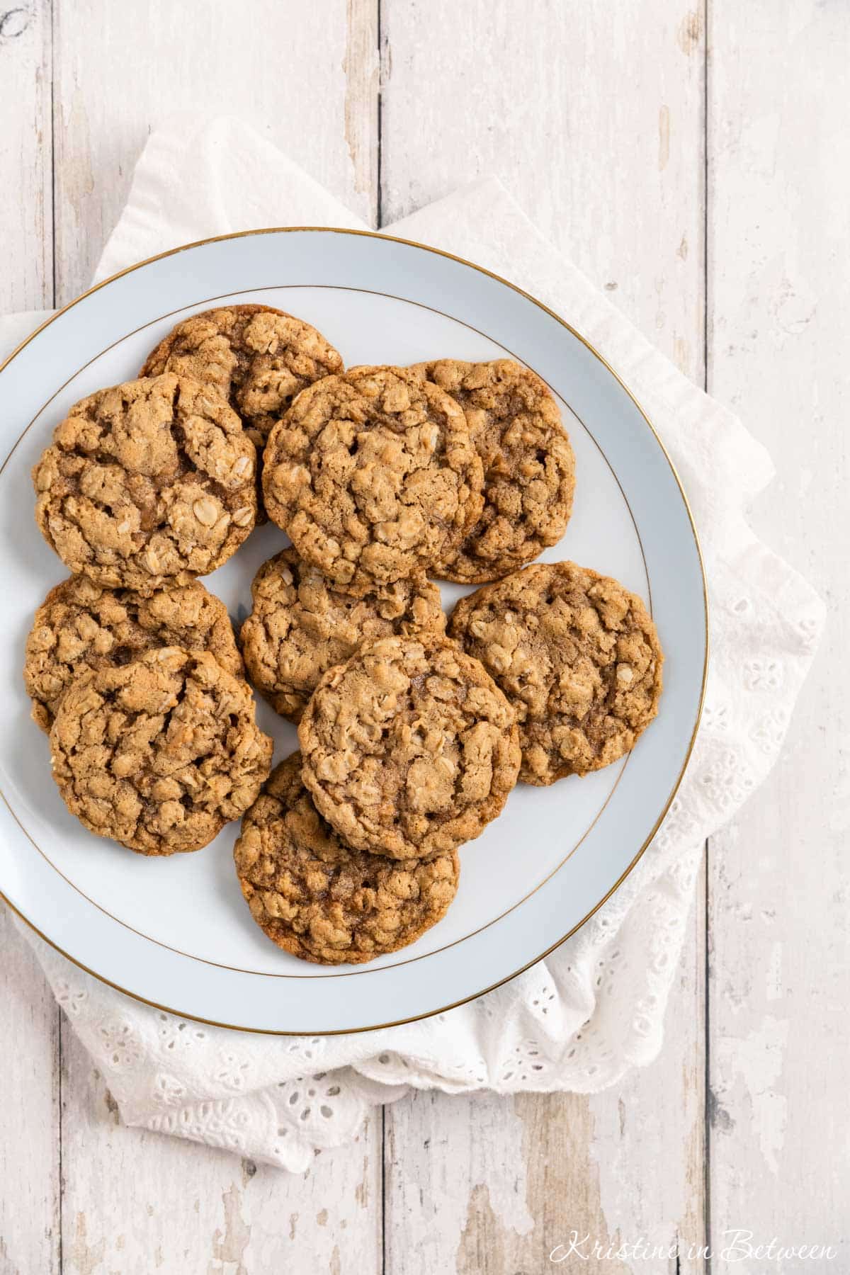 Old-fashioned oatmeal cookies on an antique china plate with an eyelet napkin underneath.