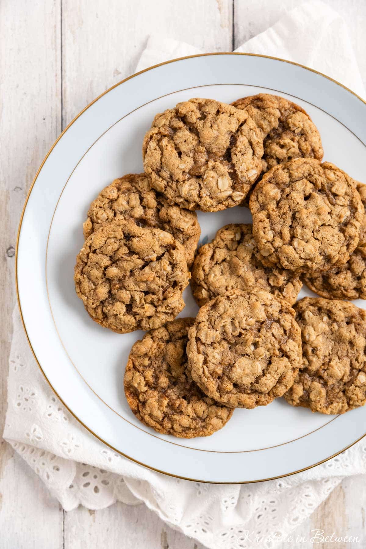 Old-fashioned oatmeal cookies on an antique china plate with an eyelet napkin underneath.