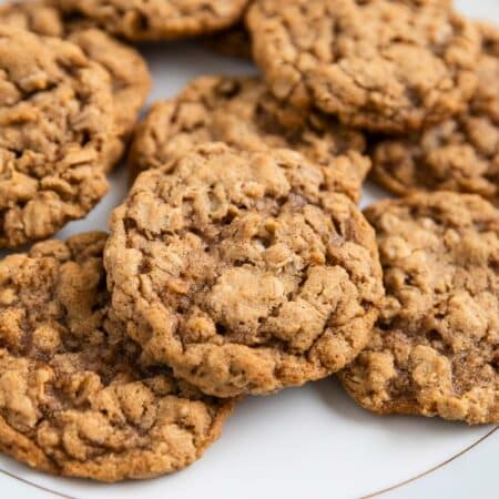 Old-fashioned oatmeal cookies on an antique china plate with an eyelet napkin underneath.
