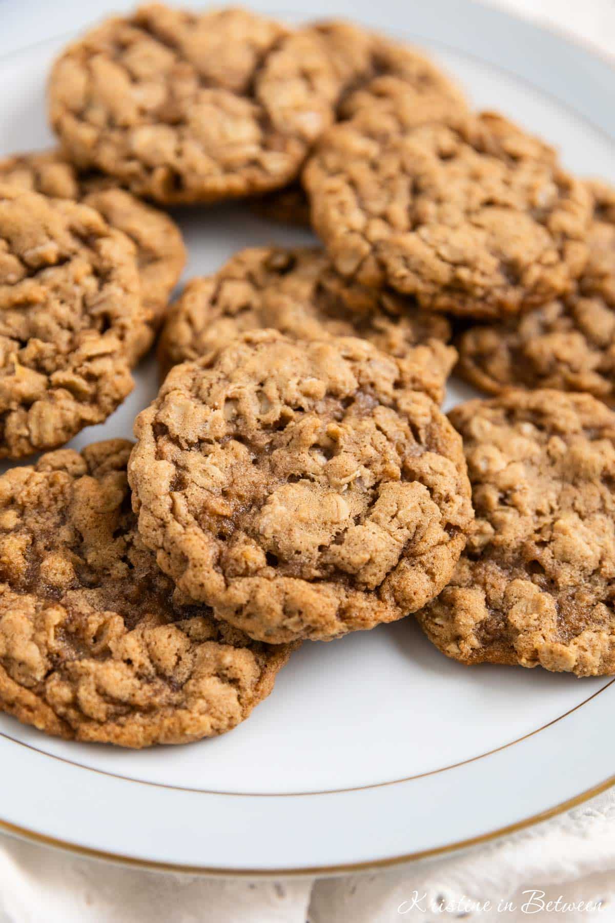 Old-fashioned oatmeal cookies on an antique china plate with an eyelet napkin underneath.