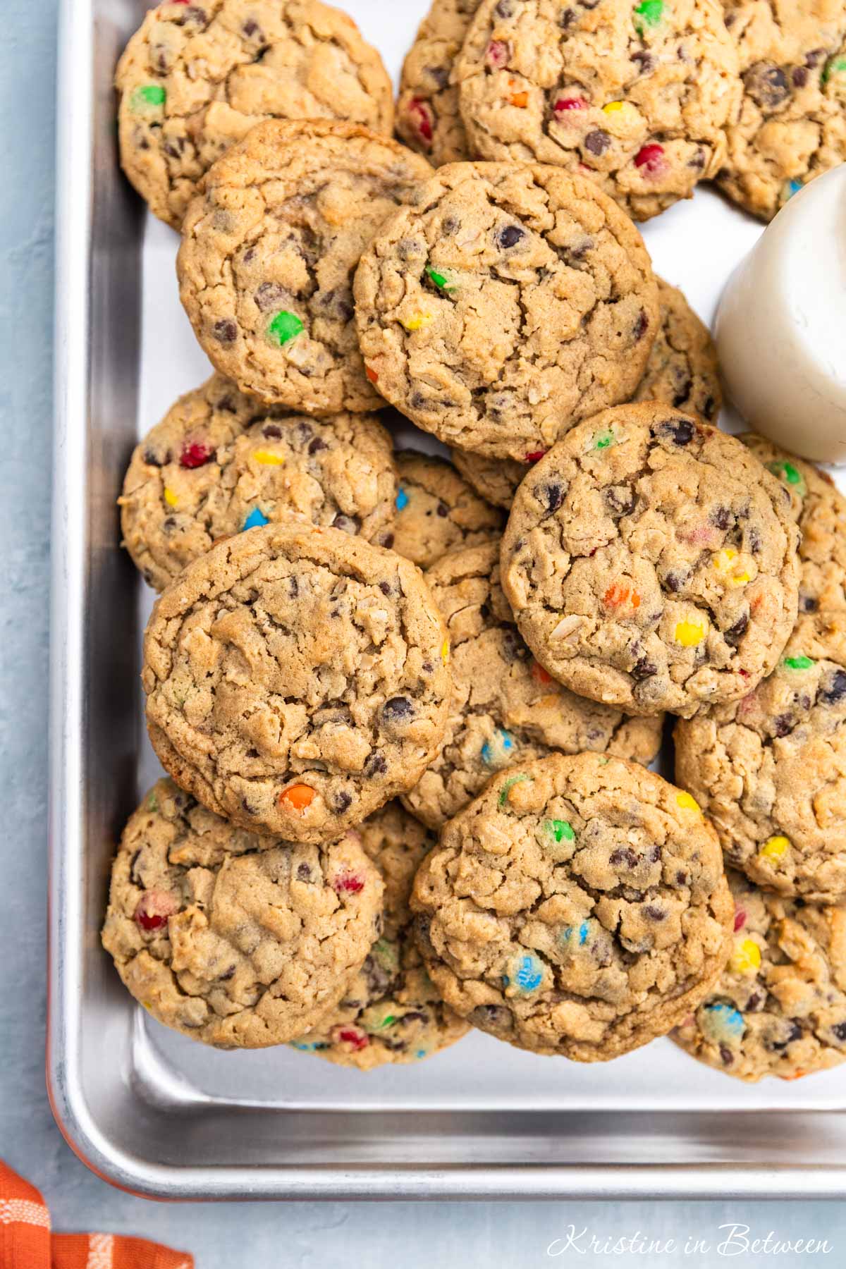 A whole tray of monster cookies sitting with an orange napkin.