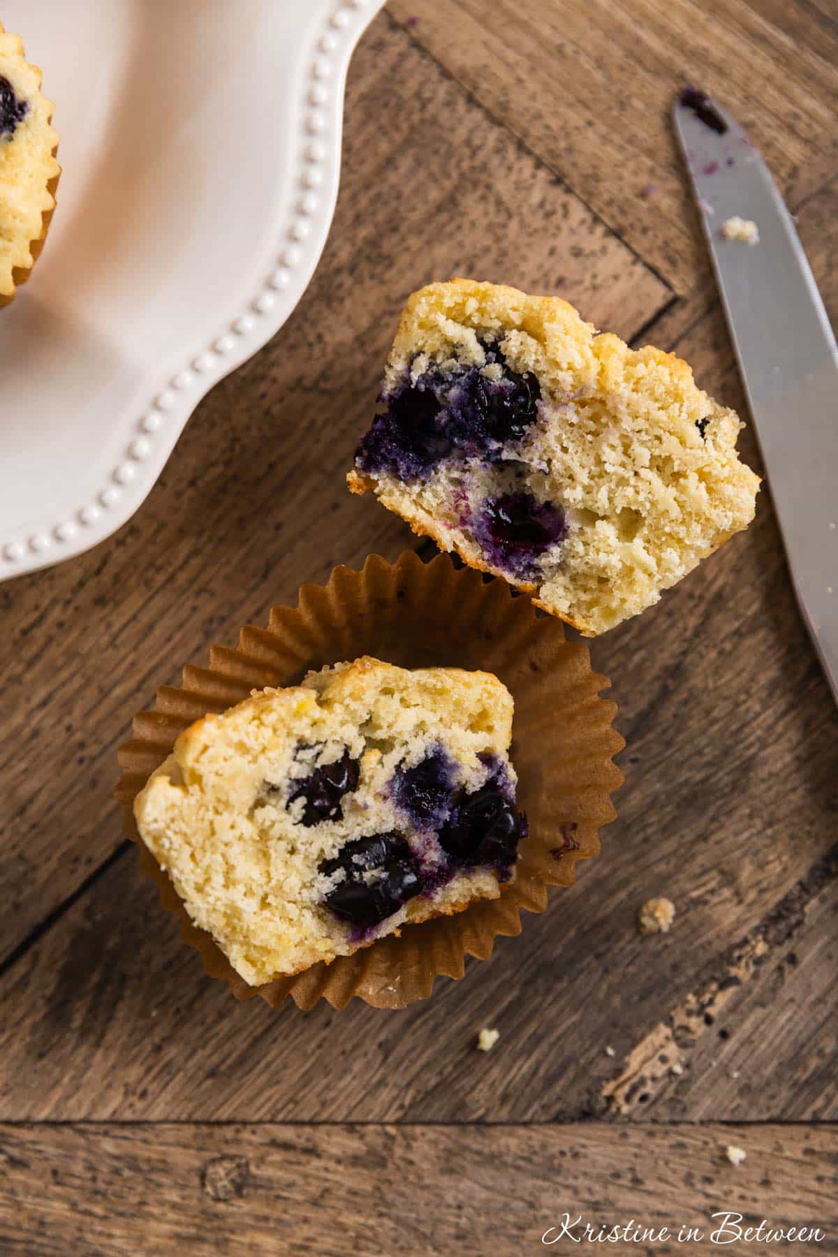 A blueberry lemon muffin cut in half to show the inside texture.