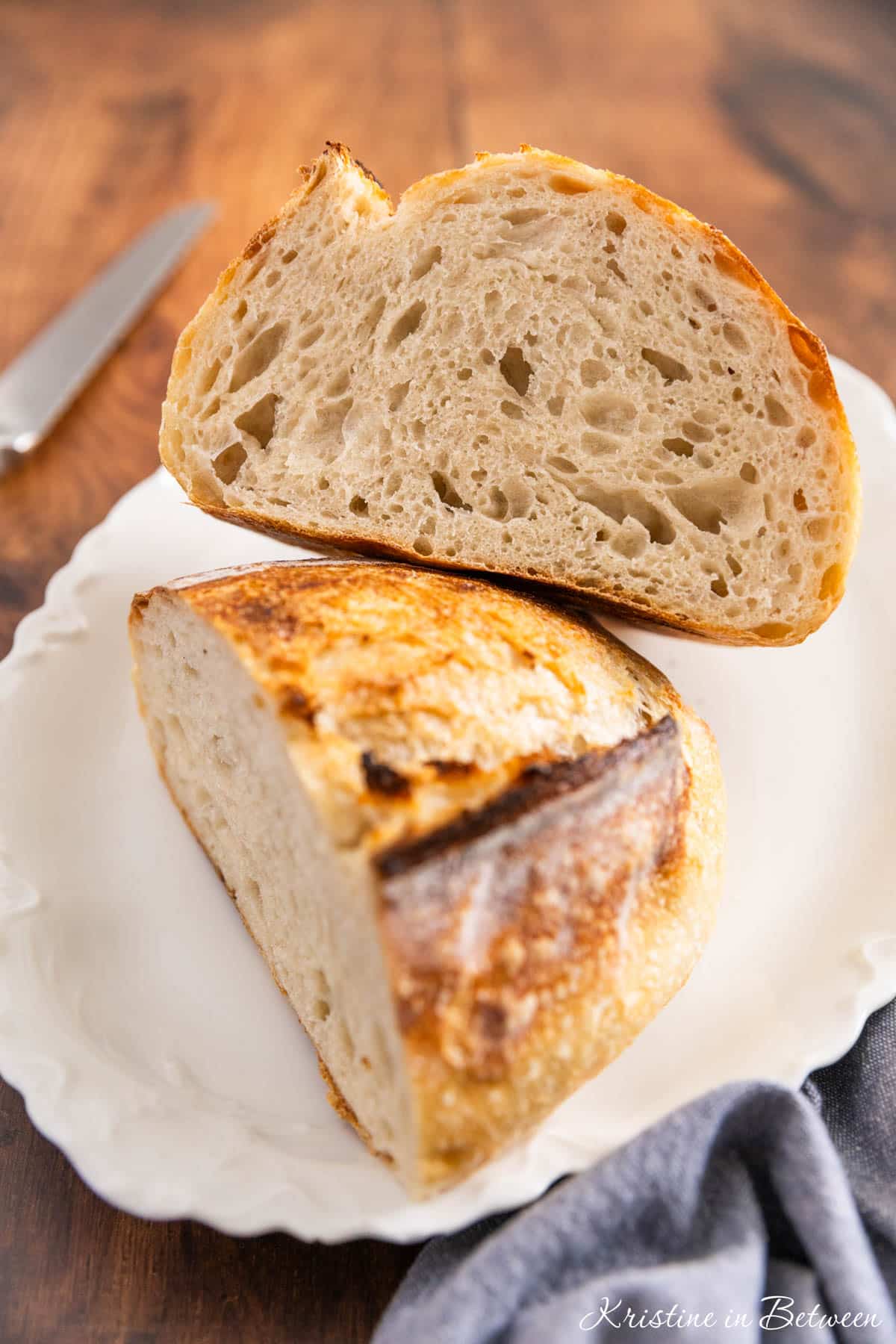 A loaf of sourdough bread cut in half to show the inside.
