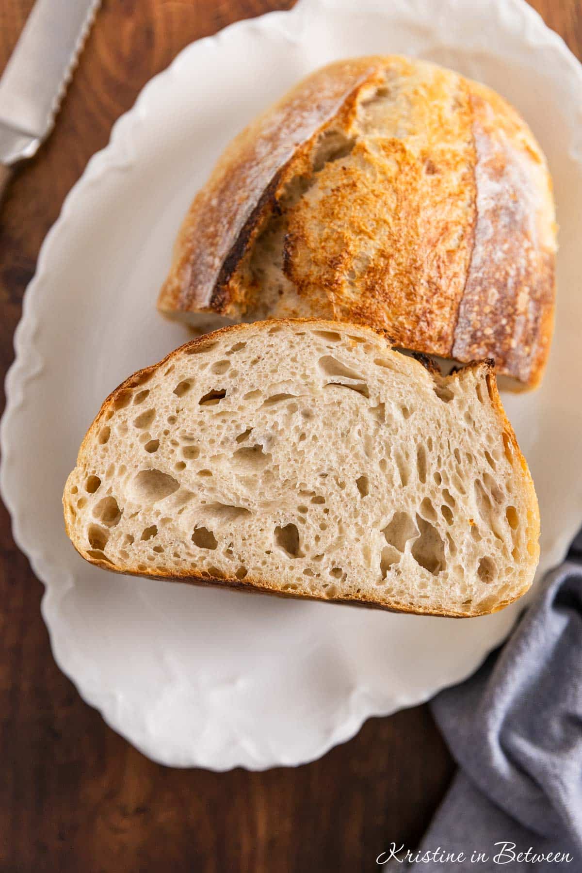 A loaf of sourdough bread cut in half to show the inside.