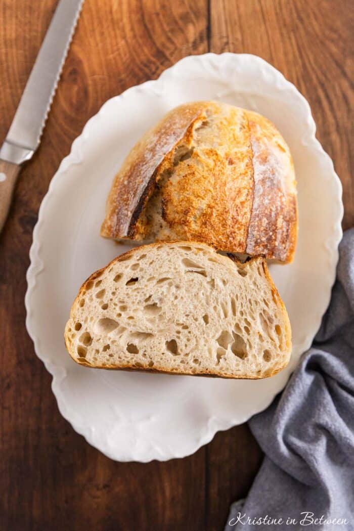 A loaf of sourdough bread cut in half to show the inside.
